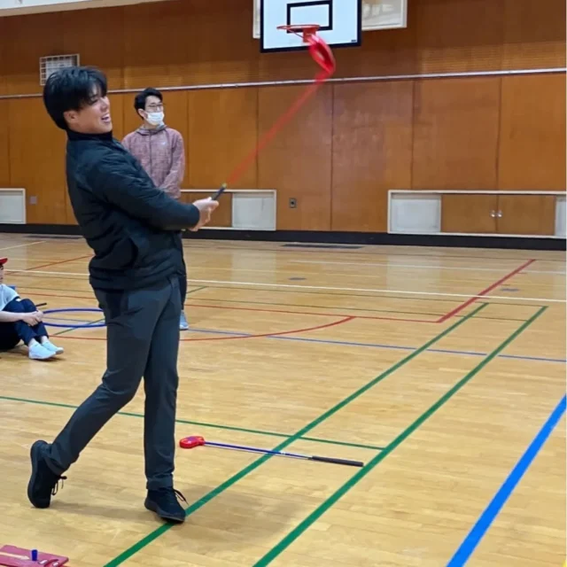 令和7年度大阪府トップアスリート小学校ふれあい事業三学期

2/25(水)、大阪市立大国小学校の5年生と6年生の皆さんにプロゴルファーの長谷川祥平プロがスナッグゴルフを教えてくださいました。

初心者の皆さんにも分かりやすく、優しく寄り添った長谷川プロの指導のおかげで、ボールをしっかりヒットできる回数もどんどん増えていきました。
楽しそうな笑顔がとても印象的で、思い出に残る素敵な時間になったのではないでしょうか。

レッスン終了後にはプロへの質問コーナーもあり、多くの皆さんが積極的に手を挙げてくれて、終始和やかで楽しい交流の時間となりました。

大国小学校の皆さん、先生方
ありがとうございました。
お疲れ様でした！

＃ジュニアゴルフクラブチーム連盟
＃ジュニアゴルファー
#JGCF #スナッグゴルフ#長谷川祥平プロ